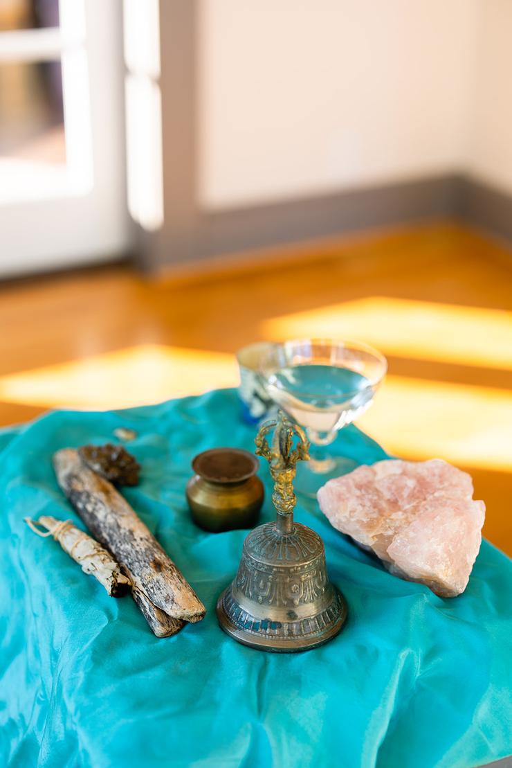 Altar with rose quartz, Ganges water, Tibetan bell, and other symbols