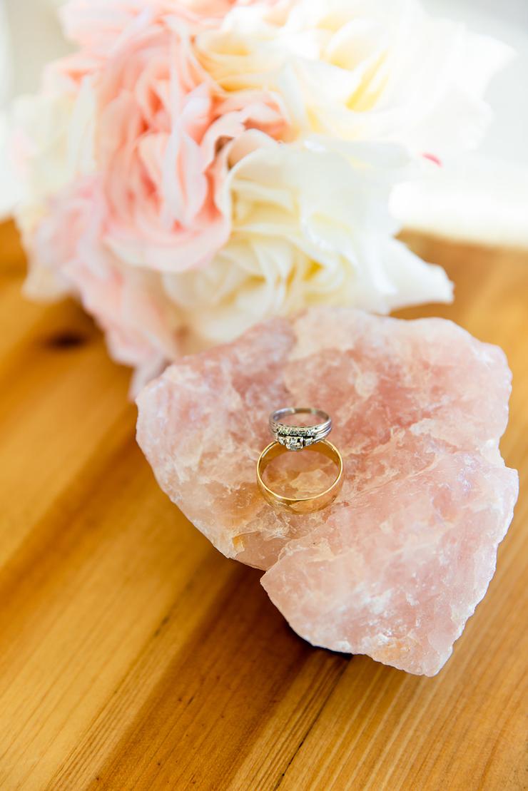 wedding rings rest on rose quartz